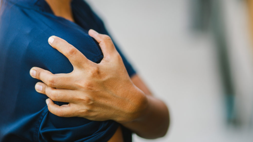 young woman with pain in shoulder